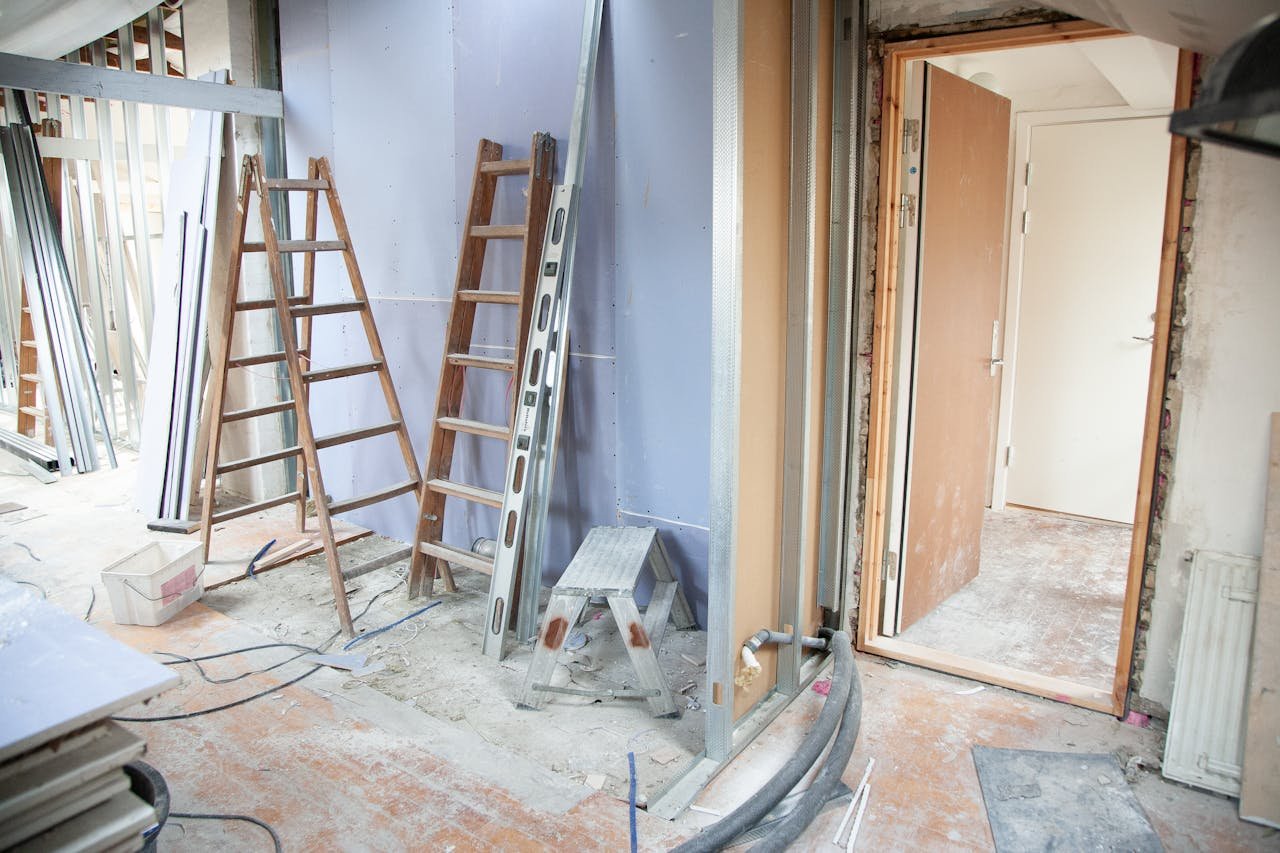 journey Construction site featuring ladders and tools in a home renovation setting.